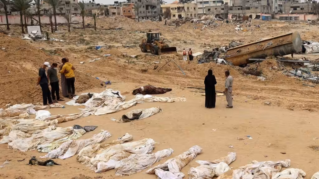 People gather near bodies lined up for identification after they were unearthed from a mass grave found in the Nasser Medical Complex in the southern Gaza Strip. Photo: AFP.