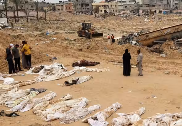People gather near bodies lined up for identification after they were unearthed from a mass grave found in the Nasser Medical Complex in the southern Gaza Strip. Photo: AFP.