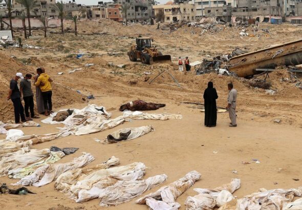 People gather near bodies lined up for identification after they were unearthed from a mass grave found in the Nasser Medical Complex in the southern Gaza Strip. Photo: AFP.