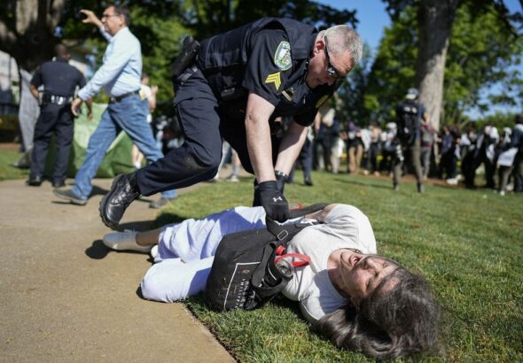 A police officer violently restrains a demonstrator at Emory University campus during a pro-Palestine protest on April 24, 2024, in Atlanta, United States. Photo: Mike Stewart/AP.