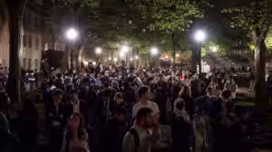 People react as protesters link arms outside Hamilton Hall barricading students inside the building at Columbia University in New York City, US, April 30, 2024. Photo: Reuters.