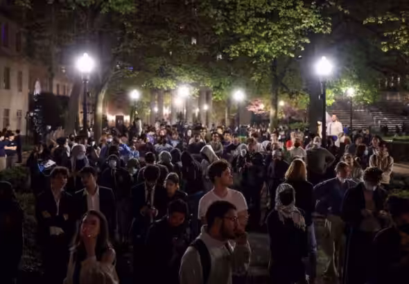 People react as protesters link arms outside Hamilton Hall barricading students inside the building at Columbia University in New York City, US, April 30, 2024. Photo: Reuters.