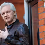 Julian Assange on the balcony of the Ecuadorian Embassy in London in 2017. Photo: Jack Taylor/Getty Images.