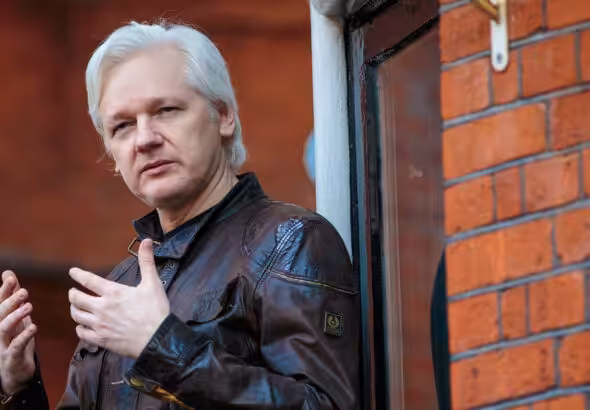 Julian Assange on the balcony of the Ecuadorian Embassy in London in 2017. Photo: Jack Taylor/Getty Images.