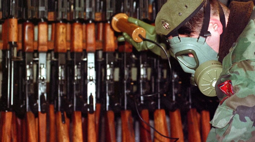 Bosnian Serb Army soldier measures levels of radiation on weapons and army equipment at a military factory in eastern Bosnian town of Bratunac 40 miles (65 kms) southeast of Tuzla, Bosnia-Herzeovina Wednesday, Jan 17, 2001. Amel Emric/AP.