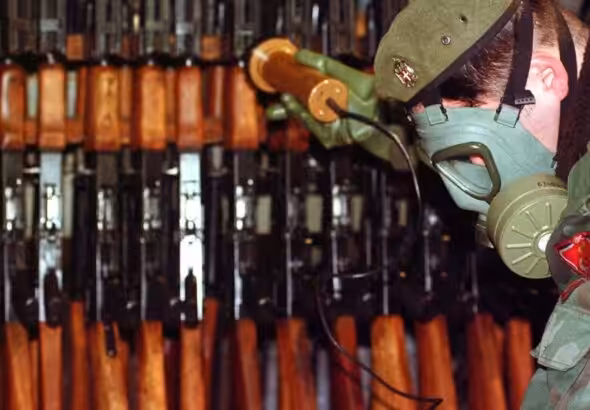 Bosnian Serb Army soldier measures levels of radiation on weapons and army equipment at a military factory in eastern Bosnian town of Bratunac 40 miles (65 kms) southeast of Tuzla, Bosnia-Herzeovina Wednesday, Jan 17, 2001. Amel Emric/AP.