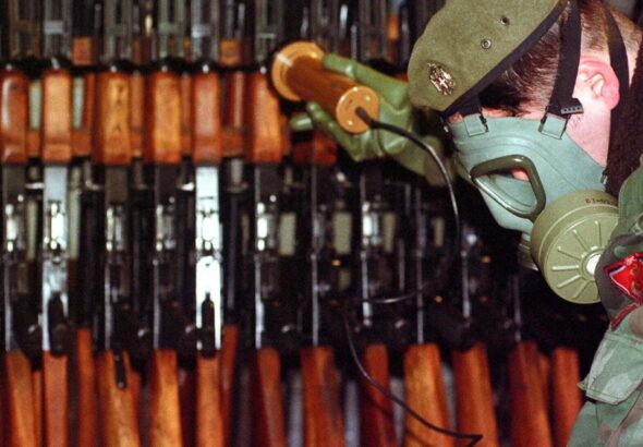 Bosnian Serb Army soldier measures levels of radiation on weapons and army equipment at a military factory in eastern Bosnian town of Bratunac 40 miles (65 kms) southeast of Tuzla, Bosnia-Herzeovina Wednesday, Jan 17, 2001. Amel Emric/AP.