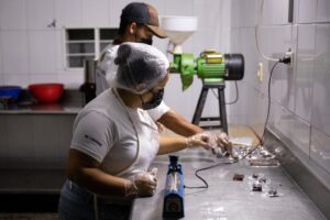 Two Venezuelan workers making cocoa-based chocolate in Las Trincheras, Carabobo state, Venezuela. Photo: EFE/Rayner Peña R.