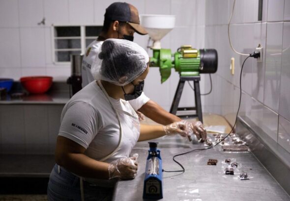 Two Venezuelan workers making cocoa-based chocolate in Las Trincheras, Carabobo state, Venezuela. Photo: EFE/Rayner Peña R.