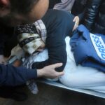 A relative mourns Palestinian journalist Akram Al-Shafi'i, killed in the Israeli bombarment of the Gaza Strip, in a morgue of the European Hospital in Rafah, occupied Palestine, January 6, 2024. Photo: AP.