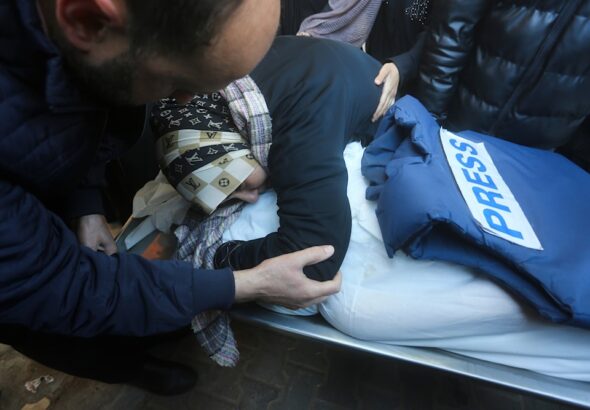 A relative mourns Palestinian journalist Akram Al-Shafi'i, killed in the Israeli bombarment of the Gaza Strip, in a morgue of the European Hospital in Rafah, occupied Palestine, January 6, 2024. Photo: AP.
