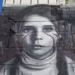 Giant mural of a girl in the side of a building. Photo: International reporters/file photo.