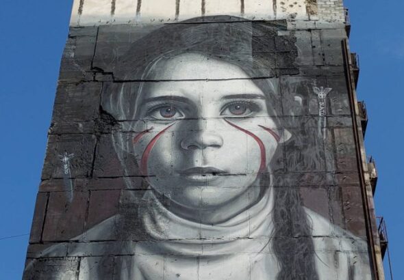 Giant mural of a girl in the side of a building. Photo: International reporters/file photo.