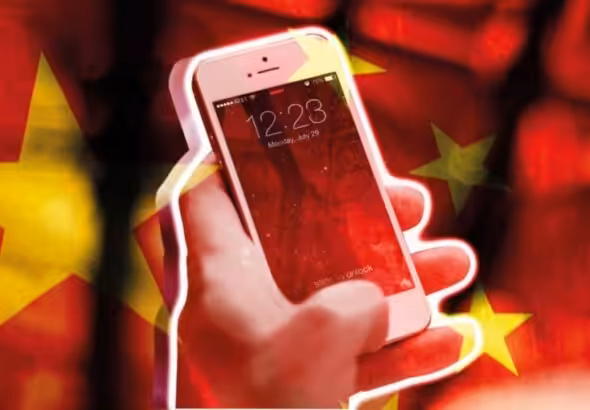 a hand holding an iPhone with a backdrop of the Chinese flag. Photo: Morning Star.