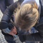 A woman assists Telesur cameraman Cristian Ibarra after he was pepper sprayed by Argentinian police while covering a protest. Photo: Telesur.
