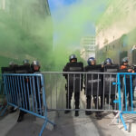 Argentinian police squad behind a barricade shooting tear gas at protesters. Photo: La Izquierda Diario.