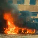 An Israeli armored personnel carrier is seen up in flames after al-Qassam Brigades elite forces in al-Shujaiya in video published by the Resistance on December 6, 2023. Photo: Al-Qassam Brigades/Military Media.