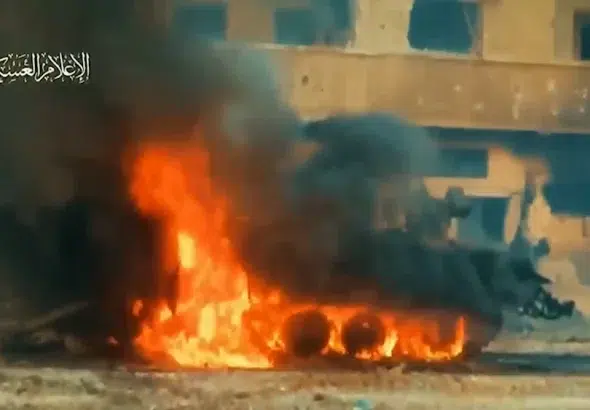 An Israeli armored personnel carrier is seen up in flames after al-Qassam Brigades elite forces in al-Shujaiya in video published by the Resistance on December 6, 2023. Photo: Al-Qassam Brigades/Military Media.