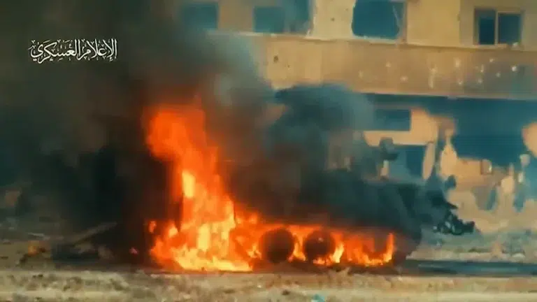 An Israeli armored personnel carrier is seen up in flames after al-Qassam Brigades elite forces in al-Shujaiya in video published by the Resistance on December 6, 2023. Photo: Al-Qassam Brigades/Military Media.