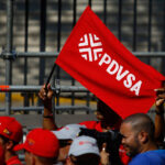 A Chavista waves a flag with the Petroleos de Venezuela SA (PDVSA) logo at a rally in Caracas, Venezuela, on January 31, 2019. Photo: Marcus Bello/Bloomberg/file photo.