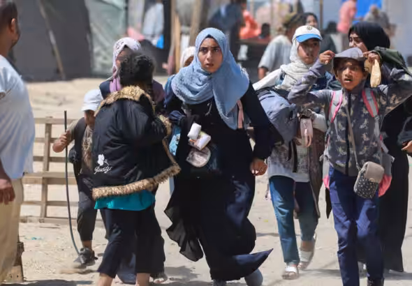 Palestinians run during Israeli bombardment in Rafah in the southern Gaza Strip on June 19, 2024. Photo: AFP.