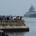 People crowd along the Havana Bay to watch the Russian Navy warship Admiral Gorshkov on its way dock in Cuba. Photo: X/@runews.
