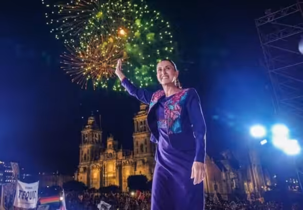 With fireworks in the background, Mexican-elect President Claudia Sheinbaum greets the crowd gathering at the Zocalo in Mexico City to hear her victory speech in the early morning of Monday, June 3, 2024. Photo: X/@mario_delgado.