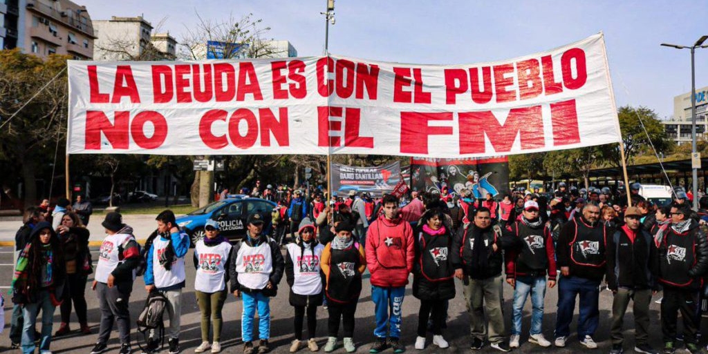 Argentinians hold a banner that reads "The debt is with the people, not with the IMF," a recurrent slogan in protests in Argentina, referring to the country's external debt and the IMF's neoliberal austerity. File photo.