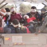 Israeli soldiers tranfer Palestinians out of the Gaza Strip, on November 21, 2023. Photo: AFP.