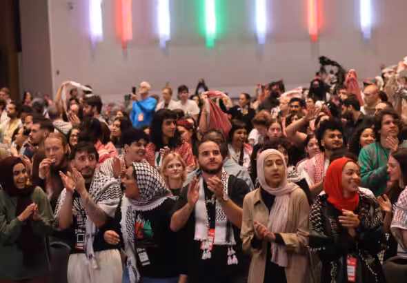 Attending activists, organizers and people applauding the conclusion of the People's Conference for Palestine, Detroit, USA, May 26, 2024. Photo: Liberation News.