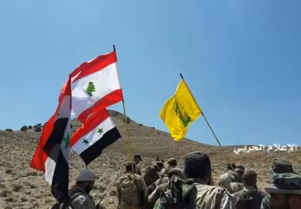 Hezbollah fighters and Syrian army units take control of a position outside Qalamoun at the Syria-Lebanon border during a battle with ISIS in 2017. Photo: Al-Manar TV.
