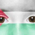 Palestinian flag over a face. Photo: Caitlin Johnstone.