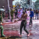Kenyan police officers intervene in people during a protest against the tax hikes in planned 'Finance Bill 2024' as they march to the parliament building in Nairobi, Kenya on June 25, 2024. Photo: AA.