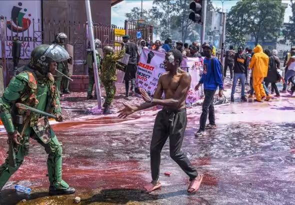 Kenyan police officers intervene in people during a protest against the tax hikes in planned 'Finance Bill 2024' as they march to the parliament building in Nairobi, Kenya on June 25, 2024. Photo: AA.