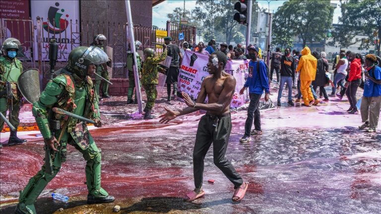 Kenyan police officers intervene in people during a protest against the tax hikes in planned 'Finance Bill 2024' as they march to the parliament building in Nairobi, Kenya on June 25, 2024. Photo: AA.