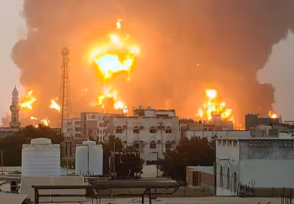 A handout picture obtained from Yemen's Ansarullah Media Center show a huge column of fire erupting following reported strikes in the Yemeni port city of Hudaydah on July 20, 2024. Photo: AFP.