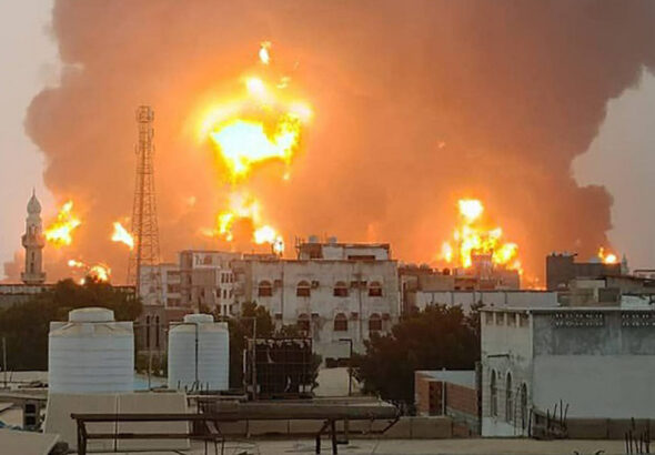 A handout picture obtained from Yemen's Ansarullah Media Center show a huge column of fire erupting following reported strikes in the Yemeni port city of Hudaydah on July 20, 2024. Photo: AFP.