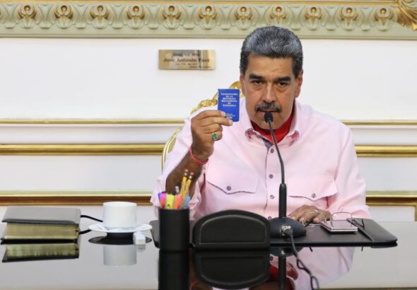 Venezuelan President Nicolás Maduro holds the Constitution of the Bolivarian Republic of Venezuela during his briefing on the far-right post-electoral violence in the country. Photo: X/@NicolasMaduro.