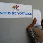 A Venezuelan voters looks for his name on the voter lists outside a polling station. File photo.