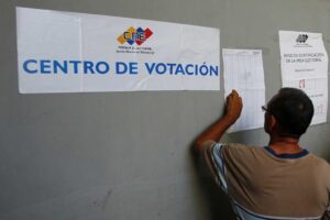 A Venezuelan voters looks for his name on the voter lists outside a polling station. File photo.