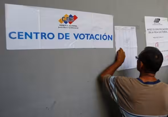 A Venezuelan voters looks for his name on the voter lists outside a polling station. File photo.