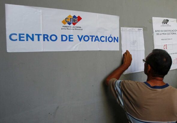 A Venezuelan voters looks for his name on the voter lists outside a polling station. File photo.