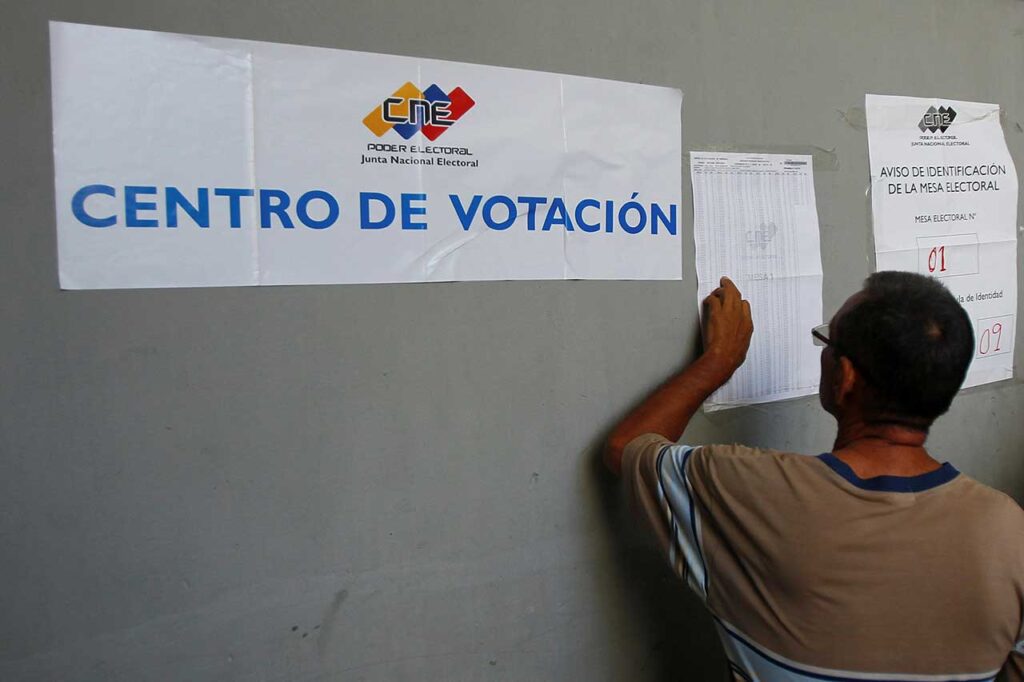 A Venezuelan voters looks for his name on the voter lists outside a polling station. File photo.