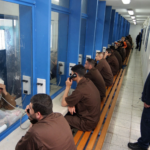Palestinian prisoners talking to family or friends. Photo: Hagai Aharon/AFP/Getty Images.