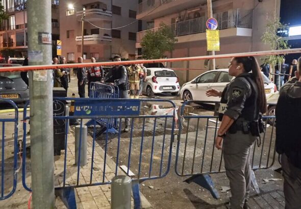 Members of Israeli forces are seen where a drone exploded in Tel Aviv on July 19, 2024. Photo: AFP.