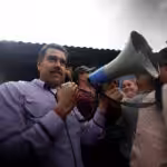 Venezuelan President Nicolas Maduro holding a megaphone under the rain while visiting and talking face to face with the inhabitants of Cumanacoa, a small town in Sucre stated heavily affected by the passing of Hurricane Beryl last week. Photo: Presidential press.