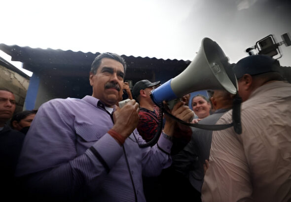 Venezuelan President Nicolas Maduro holding a megaphone under the rain while visiting and talking face to face with the inhabitants of Cumanacoa, a small town in Sucre stated heavily affected by the passing of Hurricane Beryl last week. Photo: Presidential press.