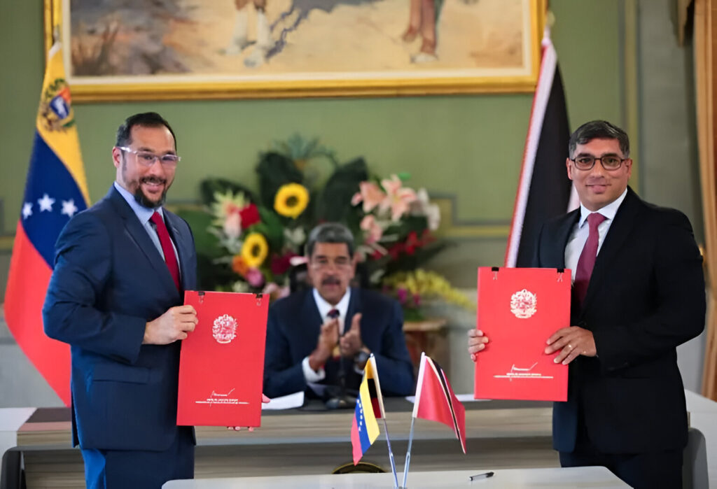 The minister for energy and energy industries of Trinidad and Tobago, Stuart Richard Young (left), and the minister for oil of Venezuela, Pedro Tellechea (right), displaying the signed energy cooperation agreements, with the president of Venezuela, Nicolás Maduro, applauding in the background at Miraflores Palace, Caracas, on July 24, 2024. Photo: Telesur.