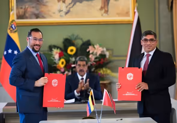 The minister for energy and energy industries of Trinidad and Tobago, Stuart Richard Young (left), and the minister for oil of Venezuela, Pedro Tellechea (right), displaying the signed energy cooperation agreements, with the president of Venezuela, Nicolás Maduro, applauding in the background at Miraflores Palace, Caracas, on July 24, 2024. Photo: Telesur.