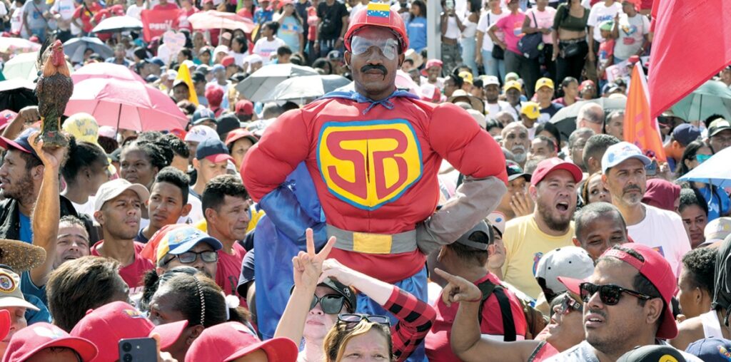 Deserved Adulation: A supporter dressed as ‘Super Bigote/Super Moustache’ a joyful reference to Nicolas Maduro’s ‘stash’ - the cartoon superhero appeared at a campaign rally in Caracas, Venezuela, July 18 2024 Photo: Ariana Cubillos/AP Photo.